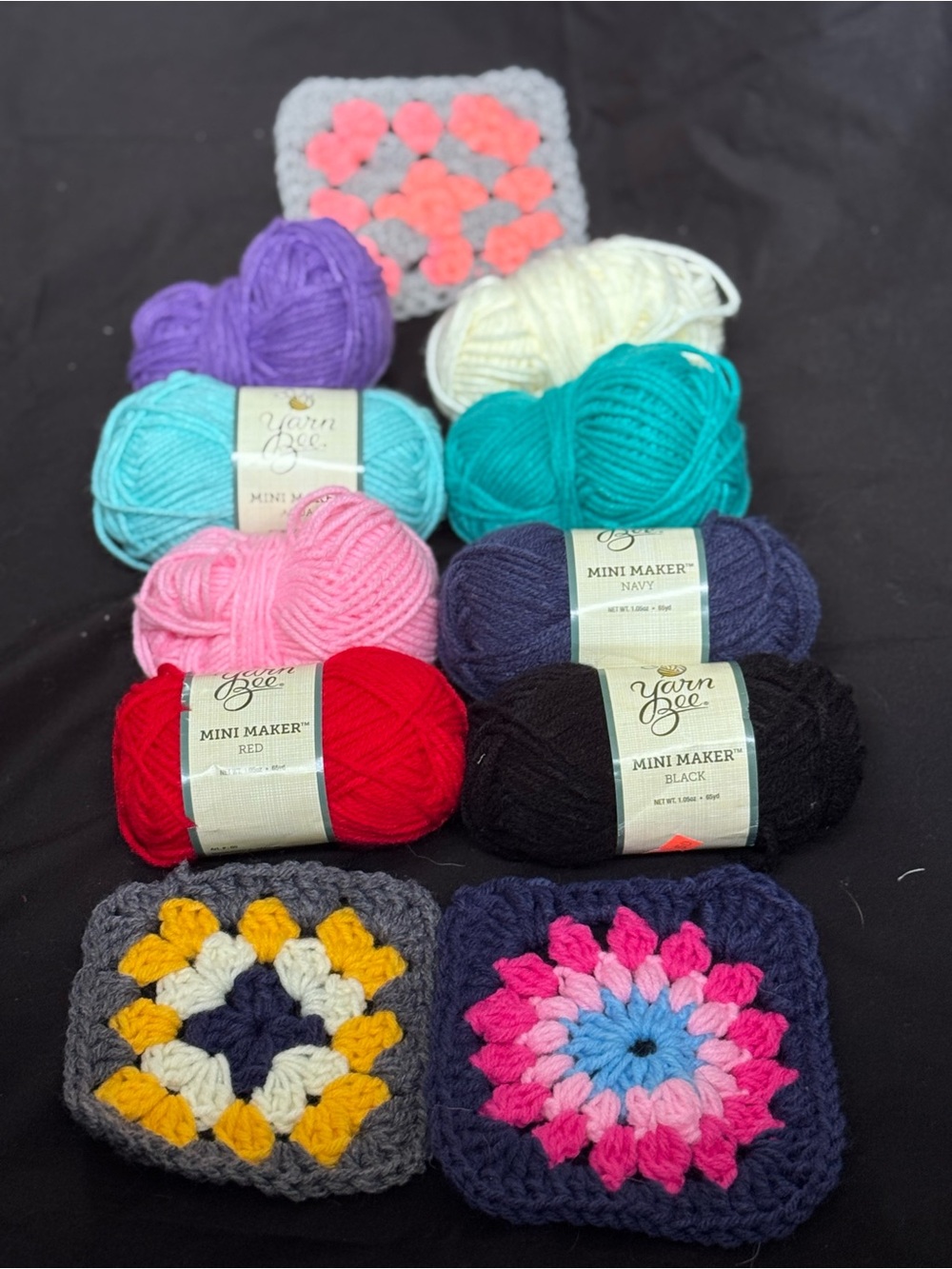 Eight skeins of acrylic yarn +3 premade granny squares